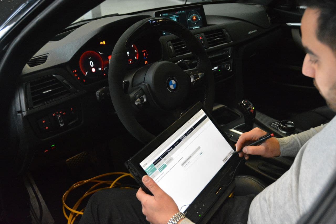 BMW interior dashboard representing coding and programming services.